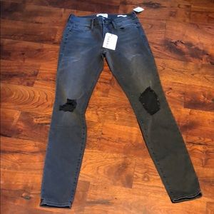 FRAME denim black jeans with holes in knees